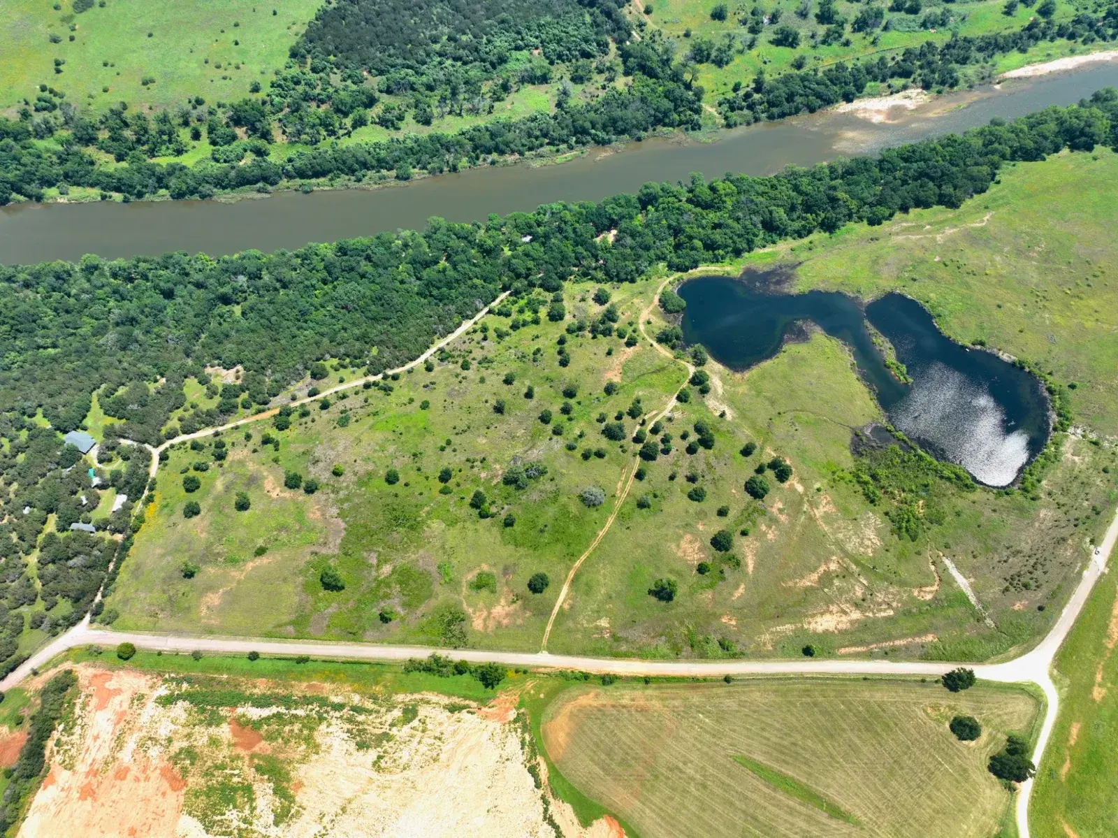 Aerial of a Texas ranch with river and pond