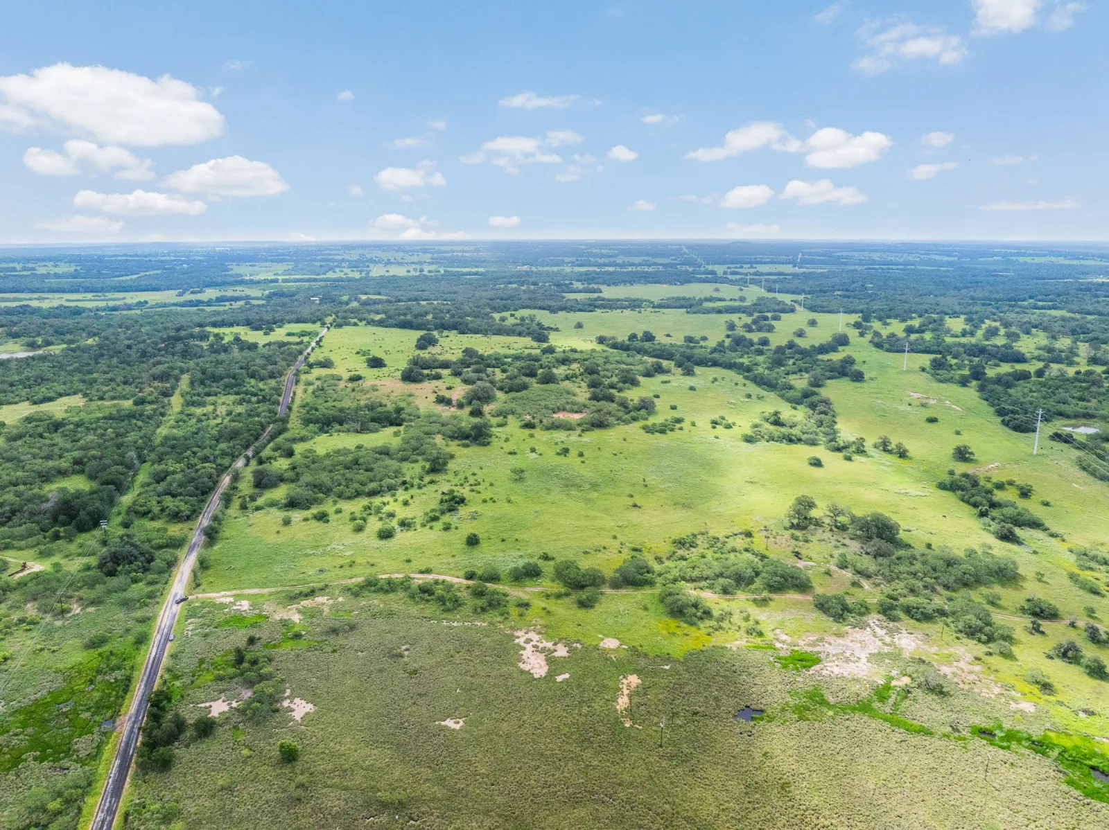 Country road through green Central Texas land
